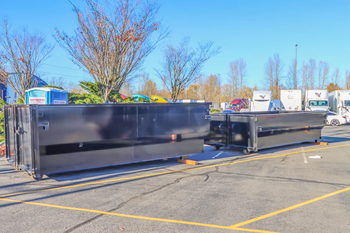 Professional dumpster rental service with roll-off container on residential driveway in Tustin